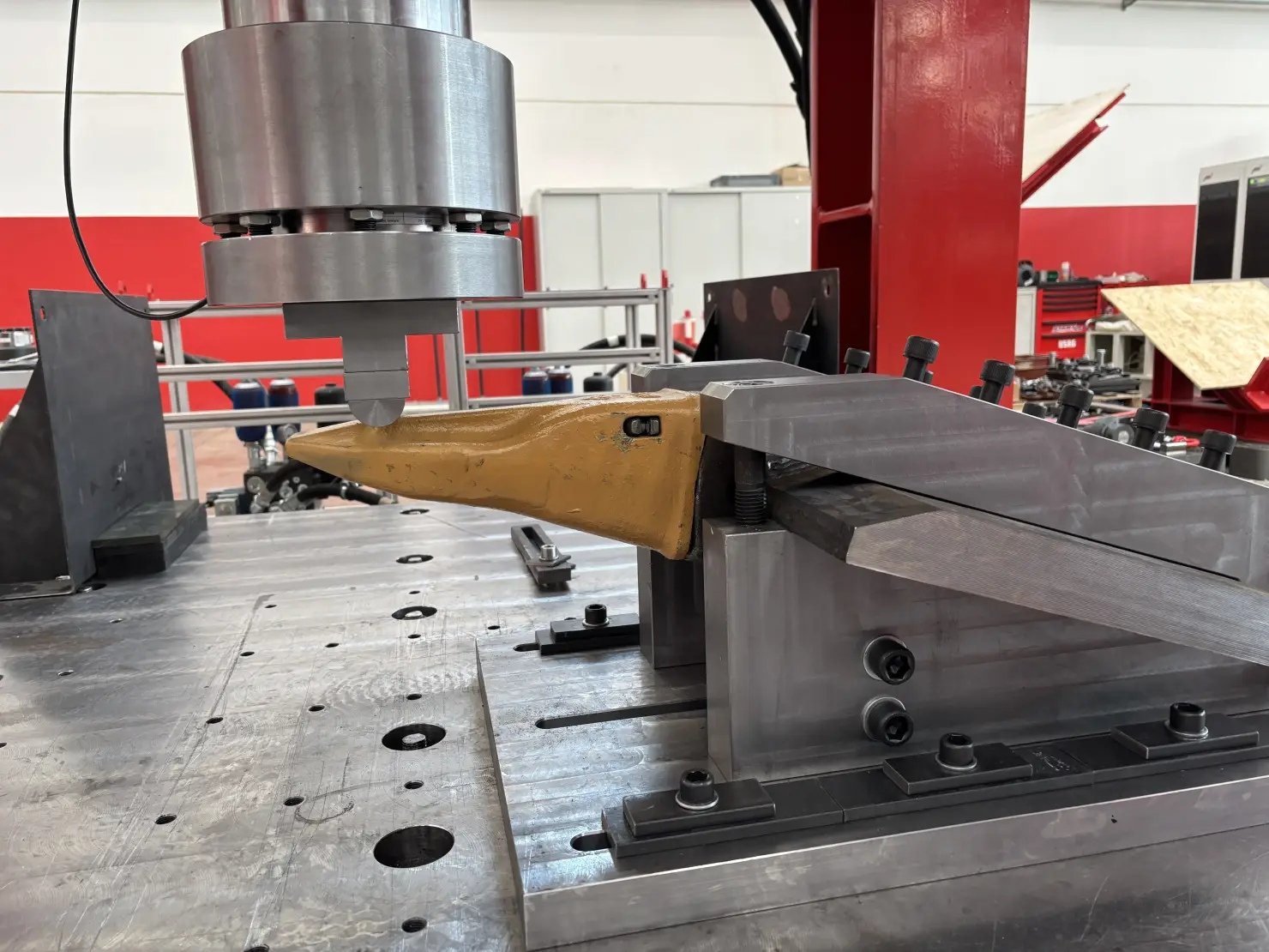 Bucket tooth held in a mechanical test fixture