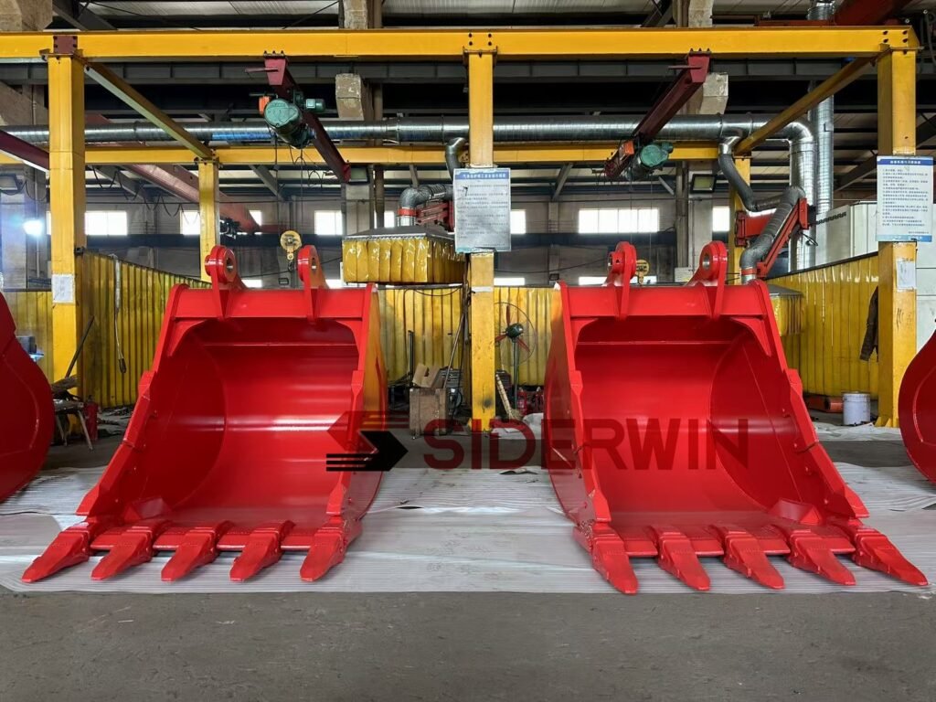 Front view of two red digging buckets with visible mounting bores