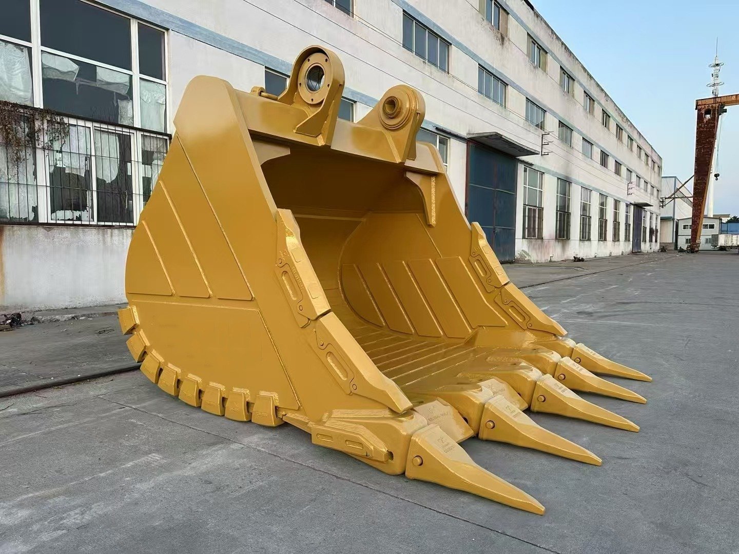 Excavator bucket with teeth and visible retaining pins