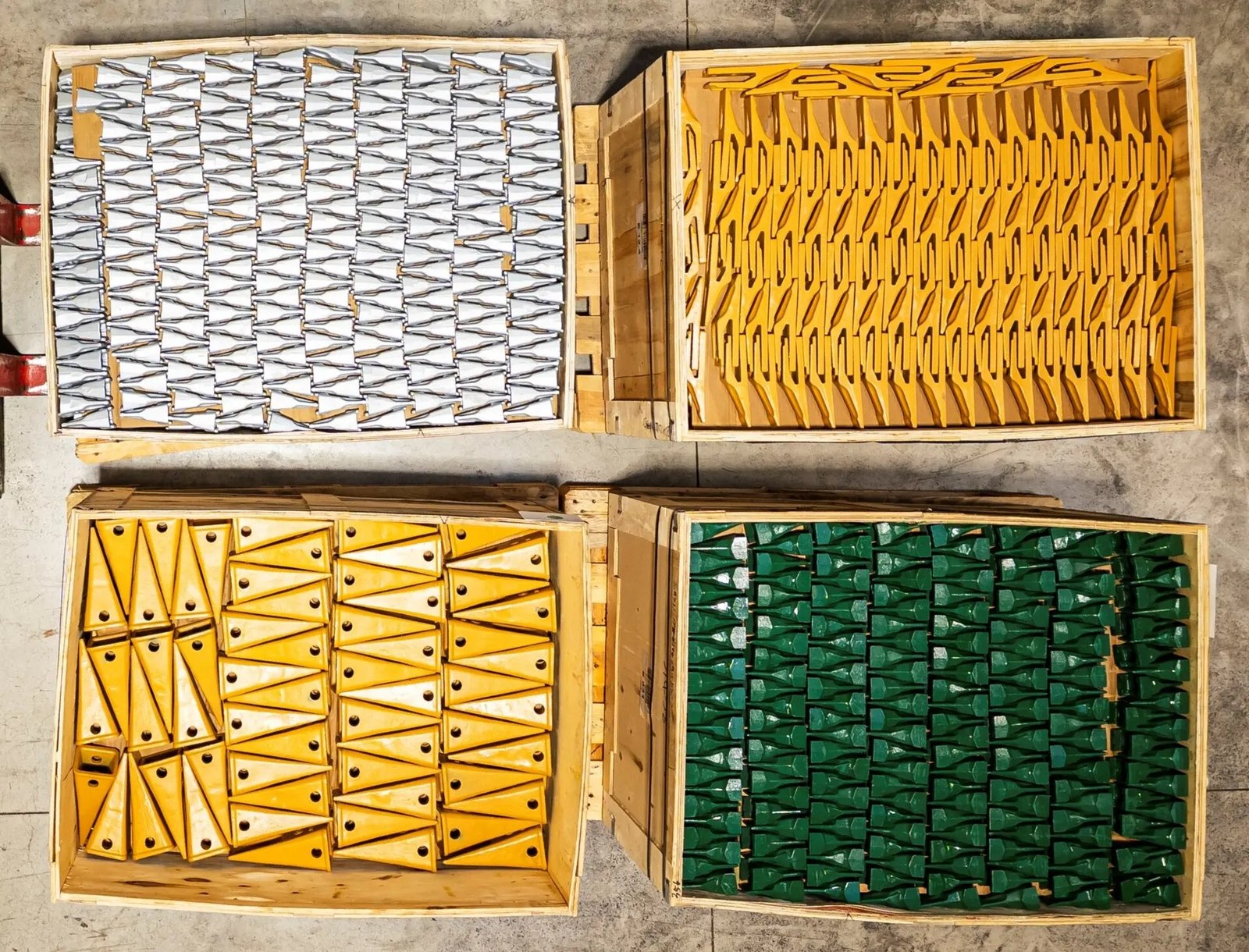Different bucket tooth profiles packed in wooden crates