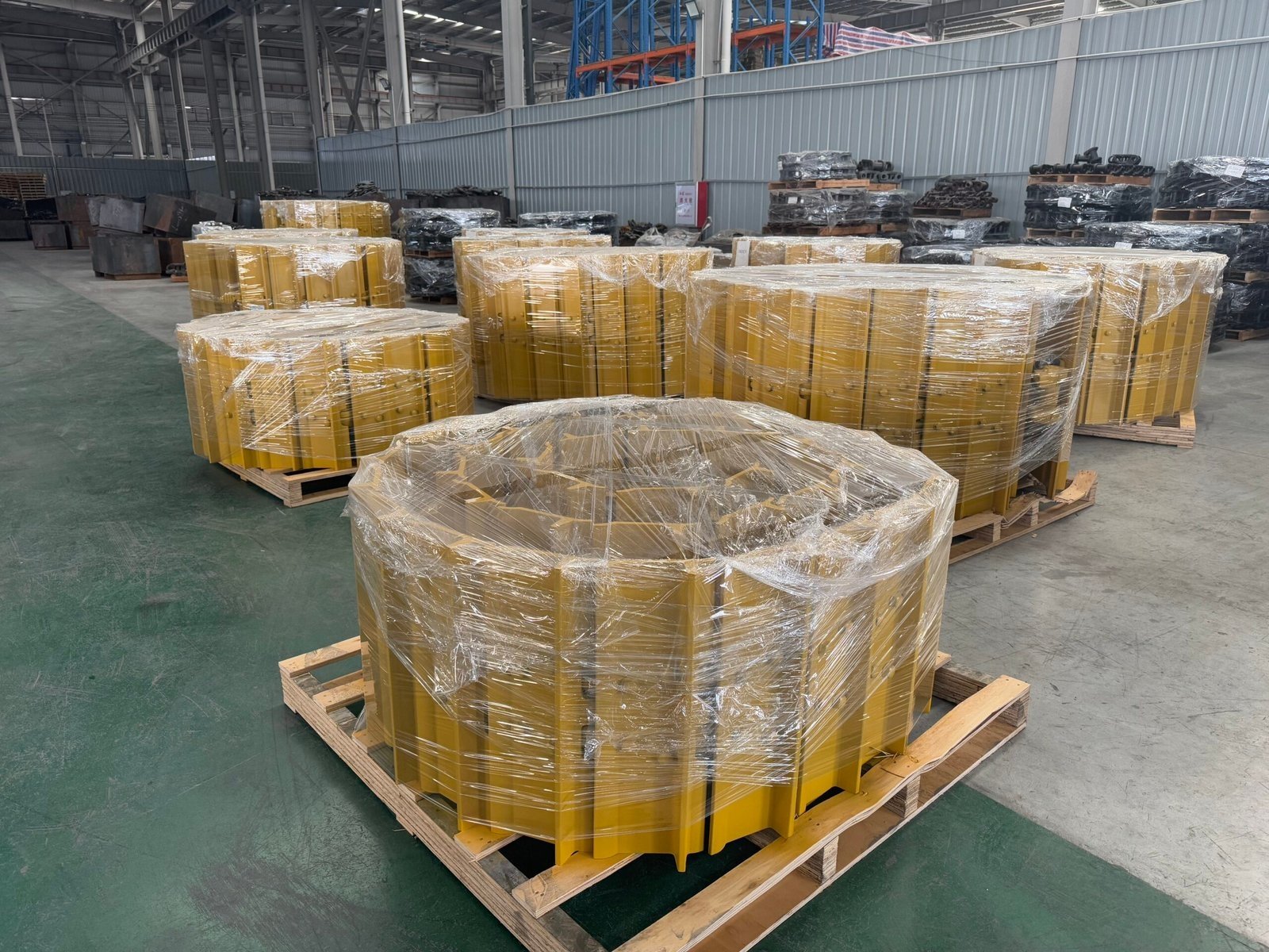 Wrapped yellow sprocket components prepared on pallets