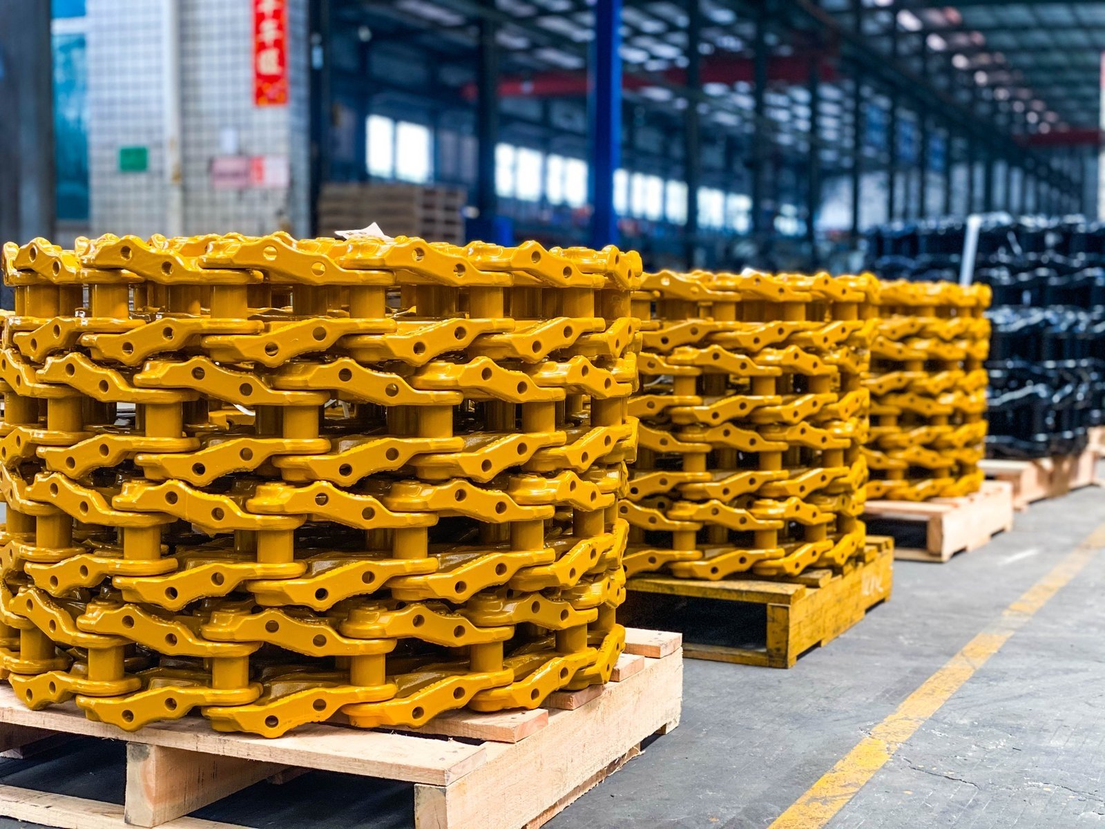 Yellow track link assemblies with visible rails and joints