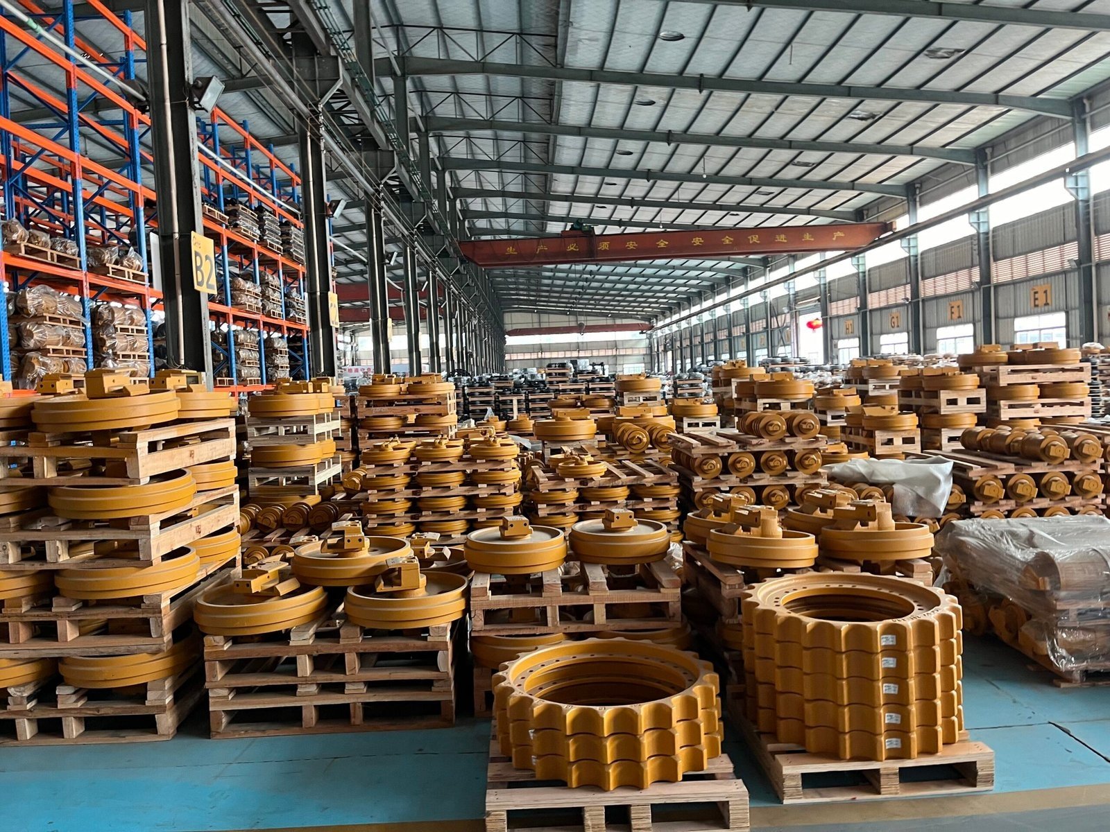 Undercarriage idlers rollers and sprockets arranged in a warehouse